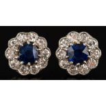 A pair of sapphire and diamond circular cluster ear studs: each set with a central,