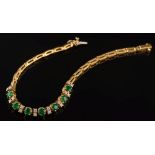 An 18ct gold, emerald and diamond bracelet: with seven,