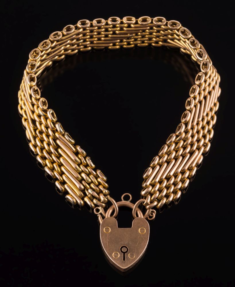 A 9ct gold mesh-link bracelet: with 9ct gold padlock clasp, approximately 19cm long, 27.