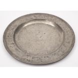 An 18th century pewter charger: of plain circular form with a moulded edge,