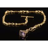 An 18ct gold watch chain with circular and elongated links, attached T-bar and gold plated,