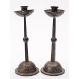 A pair of WMF Art Nouveau period alloy candlesticks: with plain cylindrical nozzles and cupped drip