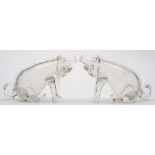 A pair of clear glass novelty decanters in the form of pigs: each in seated posture with raised