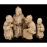 A small Japanese carved ivory okimono: of a family group depicting Lady Tang breast-feeding her