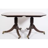 A late 19th century mahogany D-end three pillar dining table in the Regency taste:,