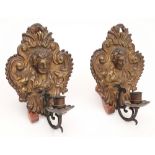 A pair of 19th century embossed brass wall sconces: each of cartouche shaped outline,