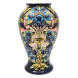 A large Moorcroft pottery vase: of baluster form tubelined in the Profusion pattern after the
