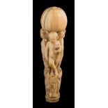 A late 18th century Continental ivory walking cane handle: the circular pommel supported by three