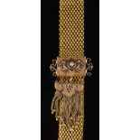 A late 19th/early 20th century gold and black enamelled mesh-link jarretiere: with tassel drop,