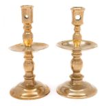 A matched pair of 17th century brass Heemskerk candlesticks: each with pierced cylindrical nozzle,