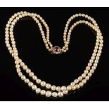 A baroque cultured pearl and natural pearl two string necklace: with 'red spinal' and diamond
