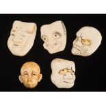 A group of Japanese ivory discs carved with humorous faces: all unsigned, each approx 3.5cm.