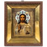 A Russian icon Christ Pantocrator : with painted features enclosed in a gilt metal oklad,