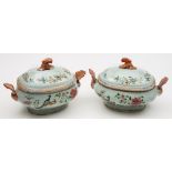 A pair of Chinese famille rose 'double-peacock' pattern tureens and covers: with rococo scroll