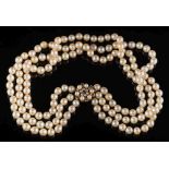 A cultured pearl three-strand necklace: the cultured pearls approximately 7mm diameter and on 9ct