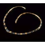 An 18ct gold, sapphire and diamond collar necklace: with baguette-cut sapphires small circular,
