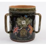 A large Doulton Lambeth stoneware Boer War commemorative three-handled loving cup or tyg: inscribed