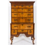An 18th century and later walnut and feather banded chest on later stand:,