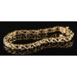 A diamond mounted line bracelet: of pierced design with circular,