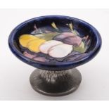 A small Moorcroft and Tudric pewter pedestal bowl: in the Plums pattern, on hammered pewter base,