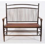 An Aesthetic movement ash twin seat settee:, with a curved spindle back,