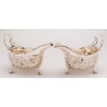 A pair of George III silver sauce boats, maker John Craig, Dublin, 1770:, crested,