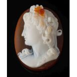 A three-layer agate oval cameo: depicting a young woman in profile looking to dexter,