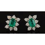 A pair of white metal, emerald and diamond rectangular cluster ear studs: the emeralds 6.