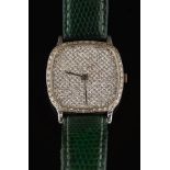 A gentleman's diamond-set quartz wristwatch: the cushion shaped dial pave-set throughout with