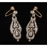 A pair of diamond pendant earrings: each with a circular,