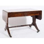 A Regency rosewood sofa table:, the hinged top with rounded corners,