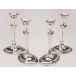 A set of four George V silver candlesticks,maker Goldsmiths & Silversmiths Co Ltd, London,