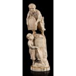 A Japanese carved ivory okimono of wheat threshers: one standing above another on a rock,