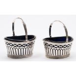 A pair of French silver swing-handled bonbon baskets: of oval outline,