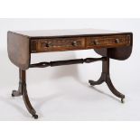 A Regency mahogany, inlaid and brass mounted sofa table:, bordered with boxwood lines,