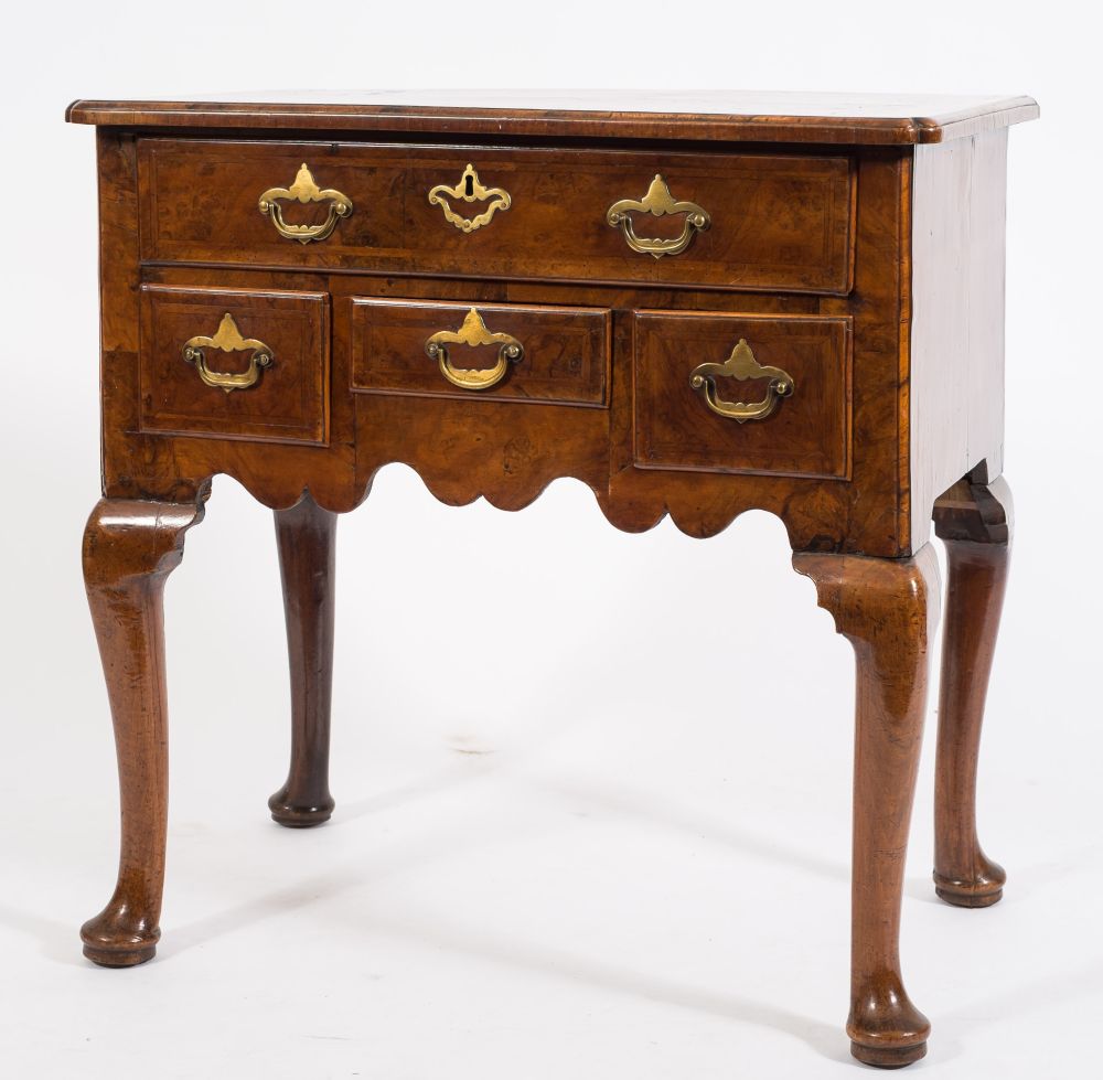 An early 18th Century walnut and cross and feather banded lowboy:,