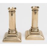 A pair of late 18th century Paktong desk candlesticks: with plain ring turned stems on stepped