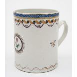 A Chinese porcelain mug: painted with a floral spray within a 'sunburst' medallion,