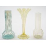 Three various 'vaseline' art glass vases: comprising a yellow tinged and white veined trumpet