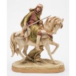 A Royal Dux Bohemia porcelain equestrian group: of a mounted Arab hunter holding a rifle with