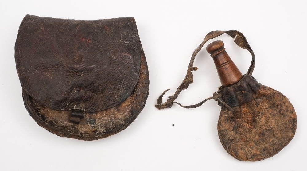 A Continental hide powder flask with treen spout together with a similar hide pouch:, (2).