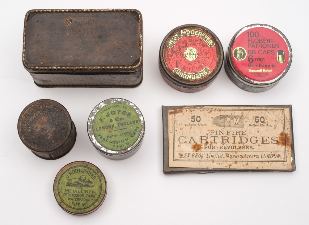 A small collection of various percussion cap tins:.