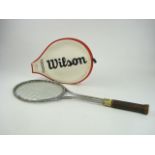 A Wilson T2000 steel frame tennis racket:, with brown leather grip and red and white racket cover,