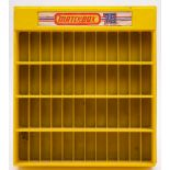 A Matchbox 75 moulded yellow plastic shop display unit: 59 x 53cm.