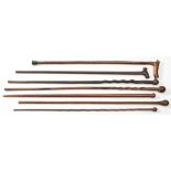 Four early 20th century lignum walking canes and three other various canes:, (4).