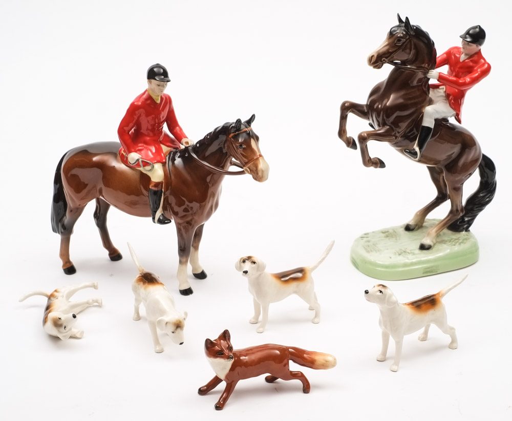 A Beswick hunting set: comprising huntsman rearing and huntsman standing, four hounds and a fox.