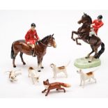 A Beswick hunting set: comprising huntsman rearing and huntsman standing, four hounds and a fox.