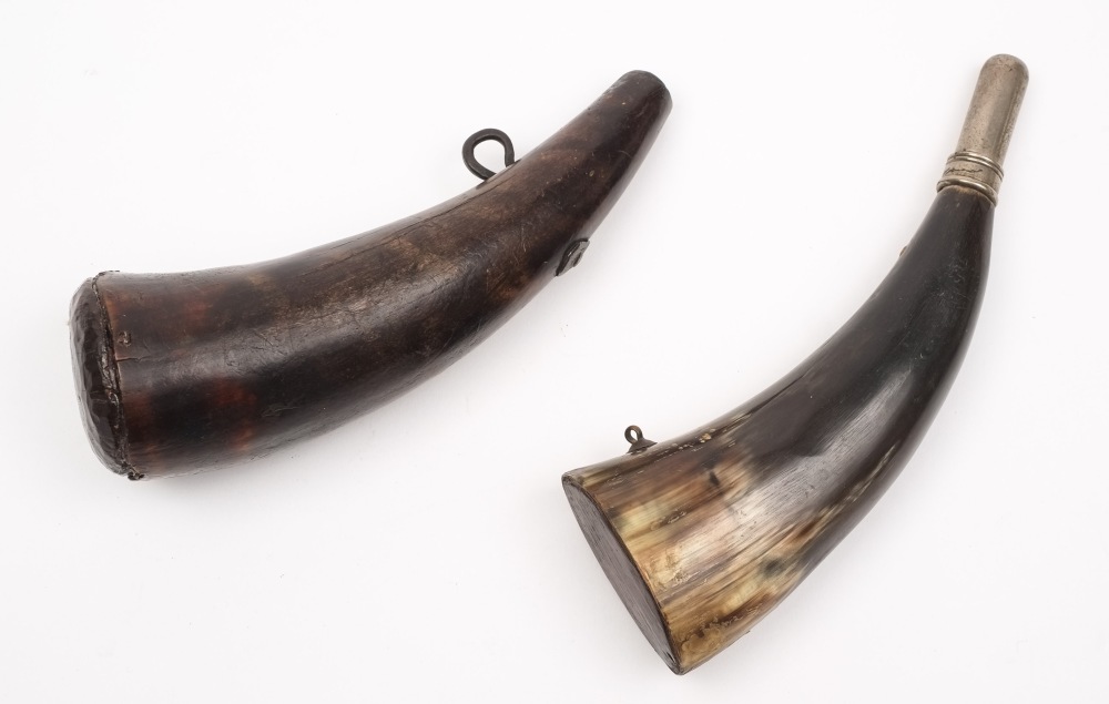 An early 19th century powder horn:, of plain form with single iron suspension and wooden bung,