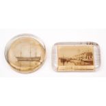 A circular glass paper weight with sepia print of HMS Victory: and a similar rectangular weight