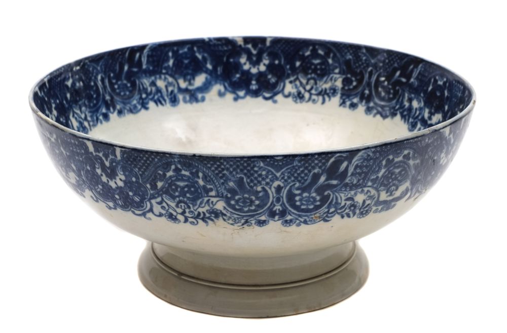 A late 18th century blue and white pearlware pedestal bowl: printed with a man o'war and inscribed